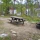 Picture of campsite with fire ring and table.