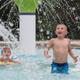 Clear photo of the campground's outdoor pool/wading area with water features and lounge chairs — good facility shot (source: homepage pool image).