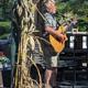 Photograph of the outdoor swimming pool with lounge chairs and RV sites visible beyond — shows on-site amenity and proximity to campsites (from the About page imagery).
