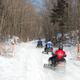 Snowmobile trail on the property through wooded grounds with groomed snow — shows winter recreational access and on-site trail network (image from main site gallery 'Down the trail').