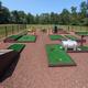 Mini-golf course area with landscaping and fenced boundary — shows on-site recreation amenity from the Photos page (https://quakerwoods.com/photos/).
