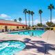 Ground-level pool view with spa and lounge chairs — clear photo of a primary guest amenity shown on the resort page.