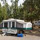 A popup camper in the woods at Tower Fall Campground