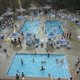 Aerial/overhead photo showing the campground's multiple outdoor pools and surrounding deck/chairs; matches the site's 'Indoor & Outdoor Pools' image on the home page, clearly a property facility.
