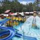 Close-up of the waterpark play structure and twisting water slides showing details of the on-site aquatic attractions and cabanas — useful facility shot.