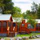 Clear photo of on-site rental cabins (row of orange cabins, picnic tables and landscaping) — shows lodging offered at this Jellystone Park property (homepage context).