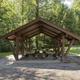 Brown Picnic Shelter with brick building in the background