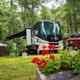 Clear photo of an RV at a well-kept campsite with flowers and wooded surroundings — shows RV site layout and landscaping on the KOA property (image is from the campground’s 'ways to stay' gallery on the Boston / Cape Cod KOA page).