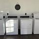 Interior photo of the laundry room with washers and dryers — documents on-site guest services and facilities.