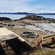 Picnic table and fire ring on sand beach