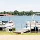 Boats docked on the lake with shoreline visible — clear view of waterfront and marina-type access at Atwood Lake (on the features/media pages).
