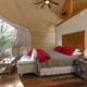 Geodome interior with large window, bed and natural-wood accents — represents the property’s geodome/glamping units and unique lodging variety.