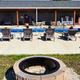 Pool and patio area with lounge chairs and the clubhouse/restroom building visible behind it; taken from the Amenities page and shows on-site recreation facilities.
