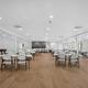 Large multi-use community hall with tables and chairs — shows an on-site event/meeting facility for guests (from the site photo gallery).