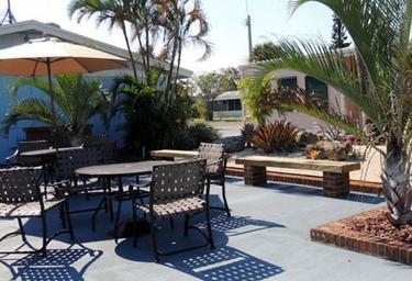 Patio seating and landscaped courtyard area with umbrellas and plants — shows another common amenity/relaxation space on the resort grounds.