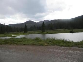 Fishing pond with mountains in background