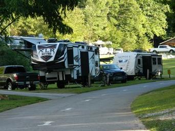 Close view of large RVs parked at full-hookup sites along a paved road — illustrates big-rig capable sites and typical spacing (source: Big Rig Sites page).