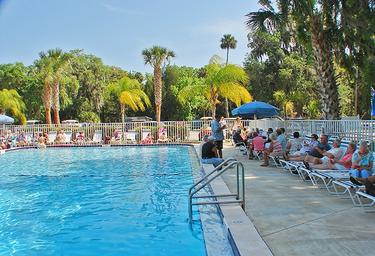 Clear photo of the resort swimming pool and pool deck with lounge chairs and landscaping — highlights a key on-site amenity referenced on the property page.