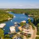 High-resolution aerial view showing the resort marina, docks, sandy beach, parking and surrounding shoreline — clear overall layout of Papa Chubby’s waterfront property (used as hero on site).