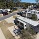 Ground-level/drone image showing individual concrete RV pads and hookups — useful to illustrate campsite amenities and pad layout (gallery drone image of on-site spaces).
