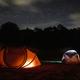 Nighttime tent campsite scene with illuminated tents and stars — useful atmospheric shot highlighting tent camping on the property (used as a homepage/background image).