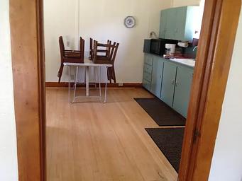 The kitchen is equipped with a modern plumbing system and electricity, table and seats for four people and a broom and a dustpan.