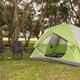 Tent campsite photo showing a green tent, chairs and trees — appears on the site’s Tent Camping page (tent-campsites) and depicts an on-property tent pitch and surrounding grounds.