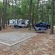 Site at campground with room for RV parking and tent space
