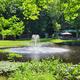 Pond with fountain and seating area visible; shows central water feature and nearby outdoor seating on the property. Source: Gallery page (Pond-Fountain) on the campground website.