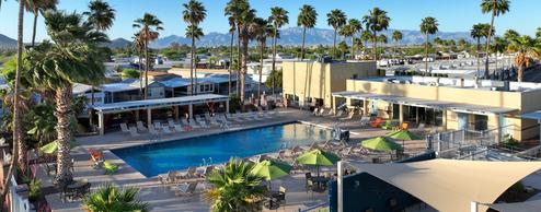 Panoramic view of the resort pool and adjacent buildings and seating — clear photo of primary on-site amenity used on the property website.