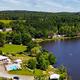 Aerial view showing the lake shoreline, adjacent grounds, pool area and campsites — clear overhead perspective matching the site’s homepage hero images and supporting the property layout.