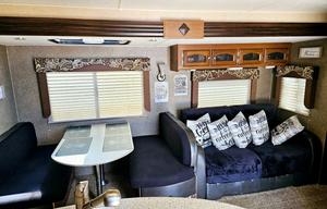 Large RV with outdoor kitchen, fireplace, and TVs