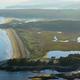 Aerial view labeled 'aerial of Reid Park' on the site; shows campground peninsula, shoreline, sandbars and overall site layout — useful overview photo for the property gallery (page: homepage/gallery).
