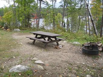 Picture of campsite with fire ring and table.