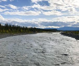 View down the Kennicott River from the footbridge — useful facility/grounds photo (page context caption: ‘From the footbridge’).