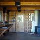 Inside of Steamer Bay cabin with wood stove and vertical ladder to loft.
