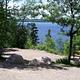 Picture of campsite and lake in the background.