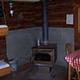 Wood burning stove and dining table inside the cabin