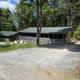 Wide exterior view of the campground’s cabin buildings and grounds — shows the main cluster of screened cabins and parking area (image from the site’s Rates page).