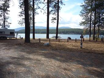 Gifford Campground with trees and lake in the background.