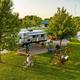 Aerial/overview of an RV pull‑through site with green space, picnic area and a swing — shows campground layout and typical RV site amenities (listed under the campground’s 'ways to stay' images).