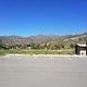 Rex Hale Campground Parking Lot with outhouse, mountains are in background