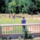Open grassy activity/field area with people and seating — represents on-site recreation space shown in the site's activities/facilities gallery.