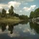 A river surrounded by trees on a sunny day