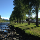 Riverside view with RVs parked along the riverbank and campground vegetation; labeled on the site's Amenities page, showing on-site riverfront campsites and facilities.