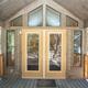 Cabin entrance/porch view illustrating cabin-style lodging on the property (door, deck and nearby spaces visible).