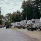 Clear view of the campground/RV pitches with gravel road and parked RVs — directly depicts the on‑site camping area (matches 'Campground' image on site).