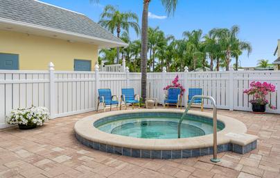 Hot tub/spa area with seating and fencing — complements pool photo and shows additional amenities. Matches gallery Hot Tub / pool deck image.