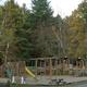 Playground with picnic tables and surrounding trees — useful facility photo showing on-site family amenities from the resort page.