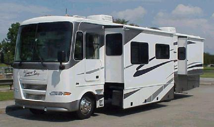 Wide shot of a large white motorhome with multiple slide-outs on the company lot; included on the site homepage and useful to show fleet variety and layout of the rental/display area (page: Motorhome Rentals and Service Center).